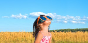 Girl with sunglasses in field