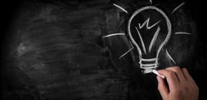 doodle-hand-lightbulb-on-chalkboard_wide