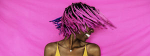 Girl shaking her pink braided hair