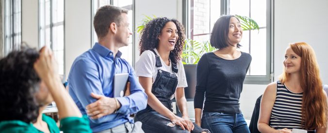 Professionals laughing in a meeting