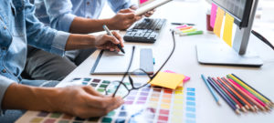 Young colleagues designers working together on a creative project and color samples for selection, Color swatch samples, Brainstorming Planning Partnership, creative graphic design working desktop